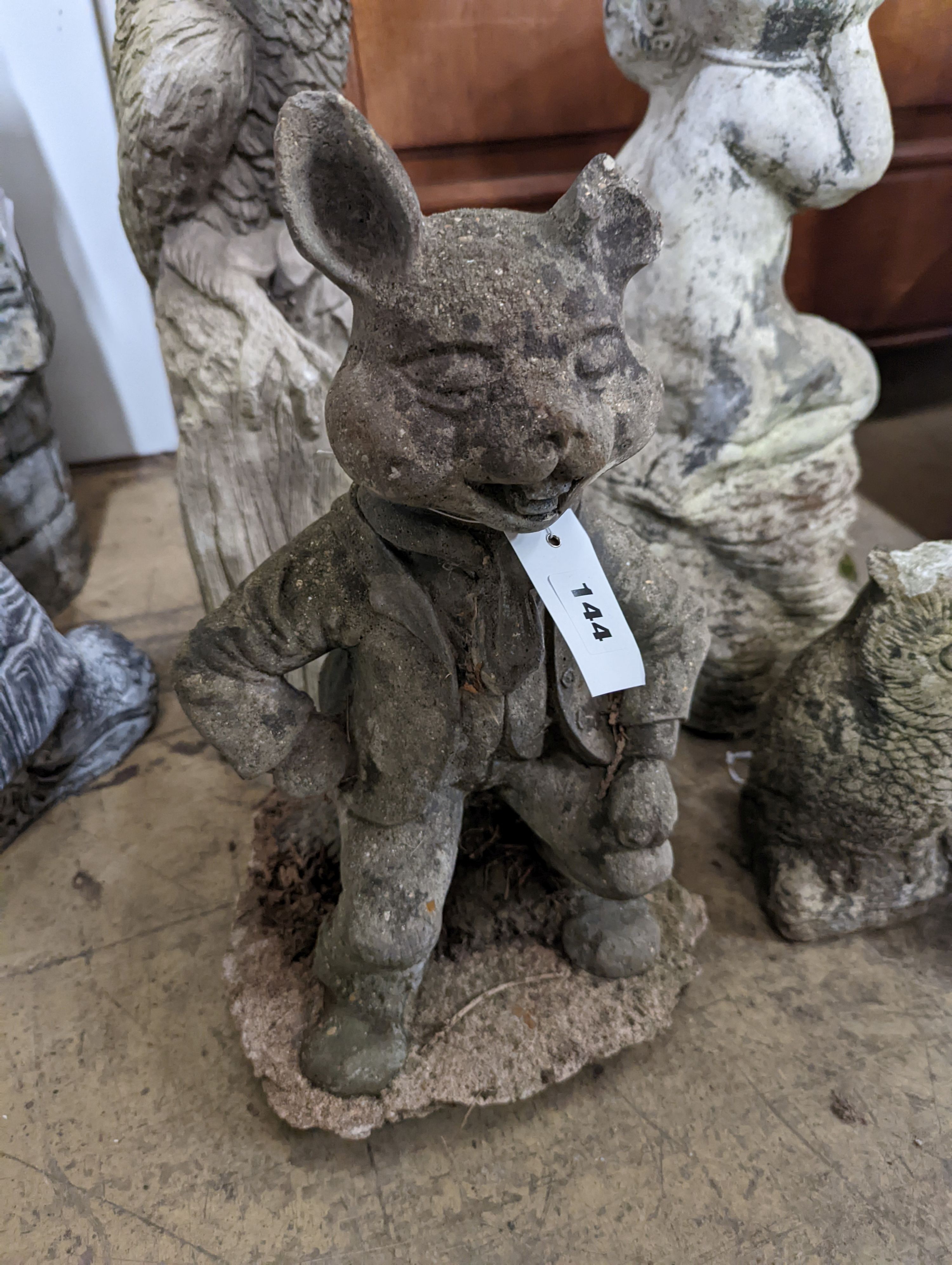 A reconstituted stone garden bird bath, height 59cm, together with four stone garden ornaments